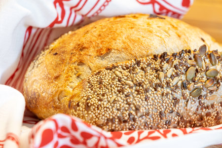 Homemade freshly bread. Sourdough wheat rye loaf with seeds still-life with napkinの写真素材
