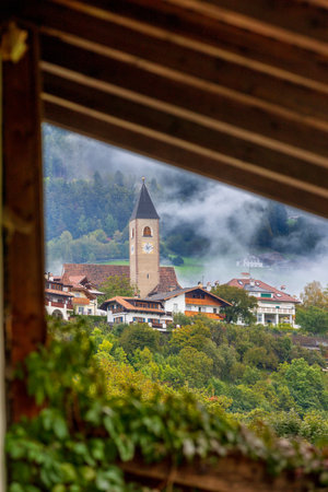 Autumn view of Parish church of Santa Croce in Siusi allo Sciliar. Castelrotto, Italy, Dolomitesの写真素材
