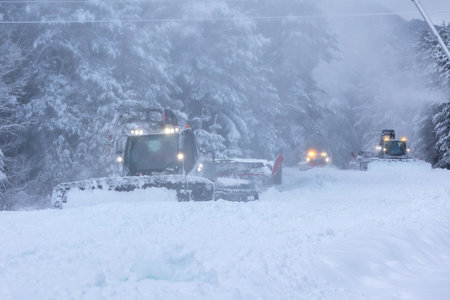 Bansko, Bulgaria snow groomer snowcat, row of ratracks machine preparing ski slope for alpine skiing, winter resortの写真素材