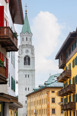 Street view with houses and church bell tower in Cortina d'Ampezzo, Italyの写真素材