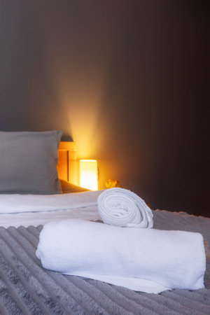 White towel on bed in guest room in hotelの写真素材