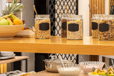 Hotel Buffet Breakfast with Cereal Options jars on the tableの写真素材