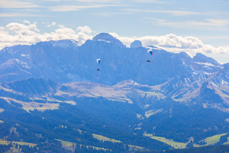 Flying paraglider, extreme sports paragliding. Mountain landscape of Val Gardena, South Tyrol, Dolomites, Italyの写真素材