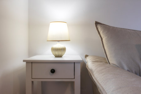 Bedroom lamp on a night stand next to the sofa, close-up