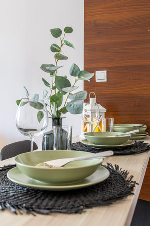 modern dining table setting with eucalyptus