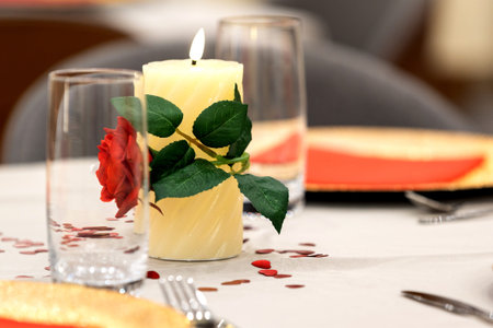 Romantic candle with red rose and hearts, elegant Valentine dinner table setting, copy spaceの写真素材