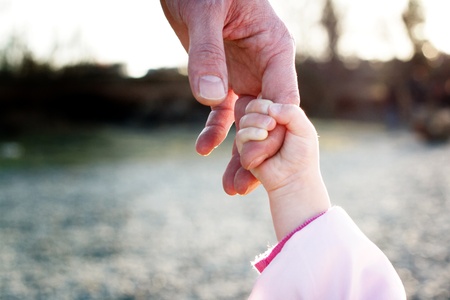 father and her daughters hand