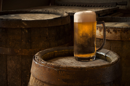 Beer barrel with beer glasses on table on wooden backgroundの写真素材