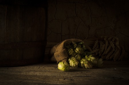 Still life with a keg of beer and hops.の写真素材