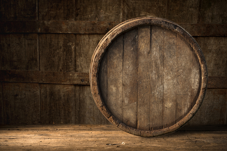 Beer barrel with beer glass on table on wooden backgroundの写真素材