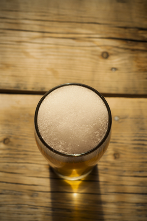 Beer barrel with beer glass on table on wooden backgroundの写真素材