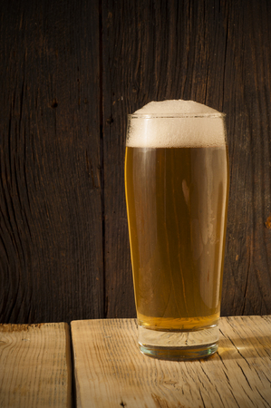 Beer barrel with beer glass on table on wooden backgroundの写真素材
