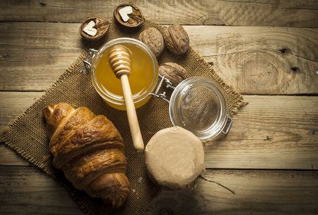 Croissants with honey in a rustic styleの写真素材