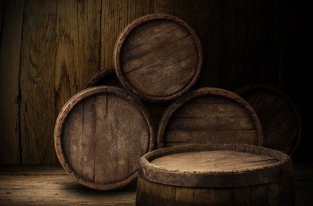 Beer barrel with beer glasses on a wooden table. The dark background.の写真素材