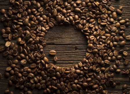 Coffee cup and saucer on a wooden table. Dark background.の写真素材