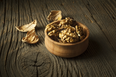 Dried walnuts with leaves wooden, wulnut, yellowの写真素材
