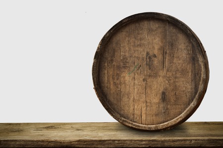 background of barrel and worn old table of woodの写真素材