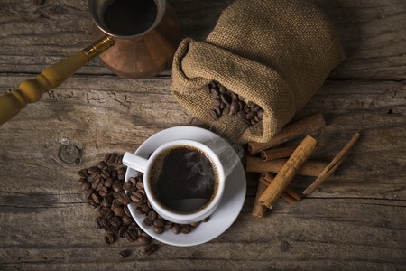 Cup of coffee with brown sugar on a wooden tableの写真素材