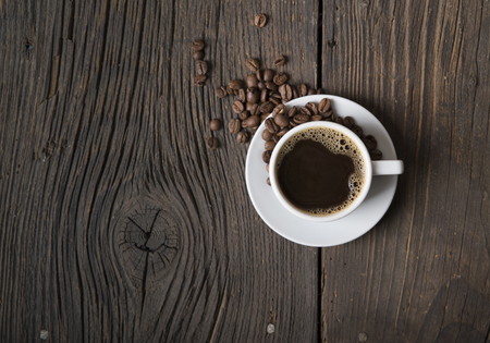 Cup of coffee with brown sugar on a wooden tableの写真素材