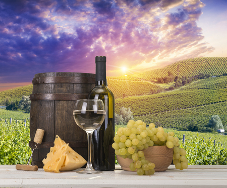 Red wine with barrel on vineyard in green Tuscany, Italy.の写真素材