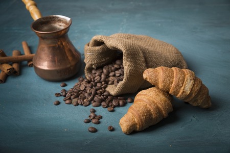 Cup of coffee with brown sugar on a wooden table.の写真素材