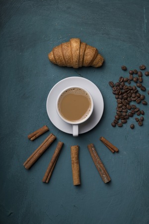 Cup of coffee with brown sugar on a wooden table.の写真素材