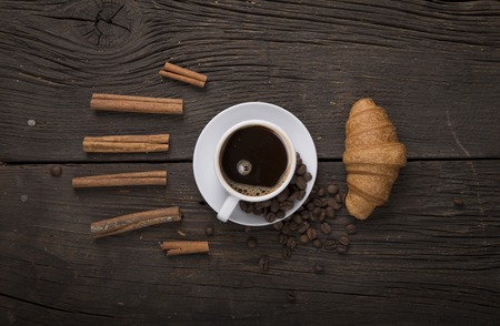 Cup of coffee with brown sugar on a wooden table.の写真素材