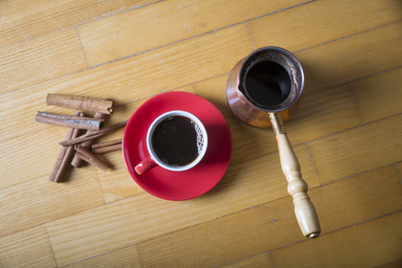 Cup of coffee with brown sugar on a wooden tableの写真素材