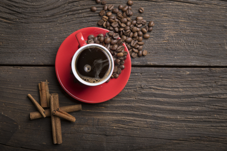 Cup of coffee with brown sugar on a wooden tableの写真素材