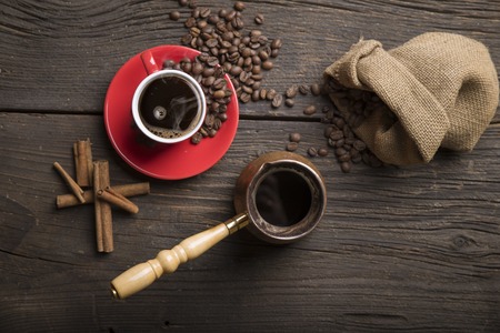 Cup of coffee with brown sugar on a wooden tableの写真素材