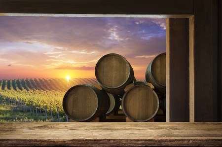 Red wine with barrel on vineyard in green Tuscany, Italyの写真素材