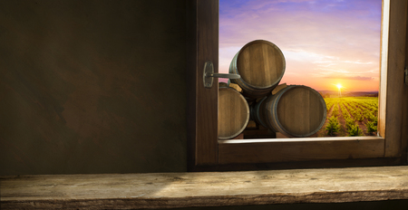 Red wine with barrel on vineyard in green Tuscany, Italyの写真素材