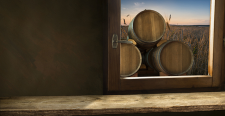 Red wine with barrel on vineyard in green Tuscany, Italyの写真素材