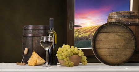Red wine with barrel on vineyard in green Tuscany, Italyの写真素材