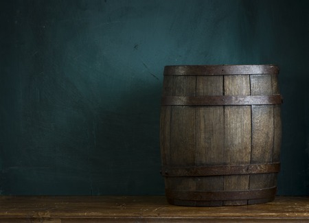 Red wine with barrel on vineyard in green Tuscany, Italyの写真素材