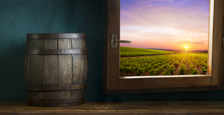 Red wine with barrel on vineyard in green Tuscany, Italyの写真素材