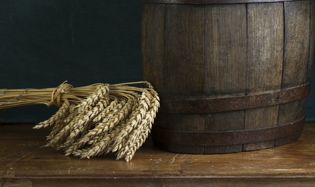 Beer barrel with beer glasses on table on wooden backgroundの写真素材