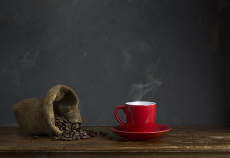 Coffee cup and saucer on a wooden table. Dark background.の写真素材