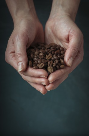 Coffee cup and saucer on a wooden table. Dark background.の写真素材
