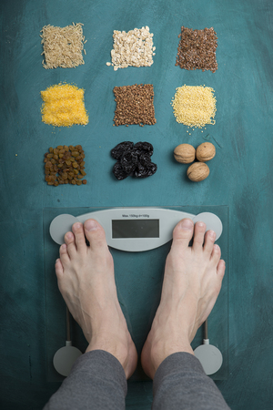 Diet. Top View Of Female Bare Feet Standing On A Scaleの写真素材