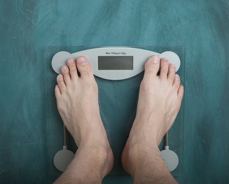 Diet. Top View Of Female Bare Feet Standing On A Scaleの写真素材