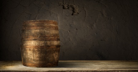 background of barrel and worn old table of woodの写真素材
