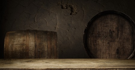 background of barrel and worn old table of woodの写真素材