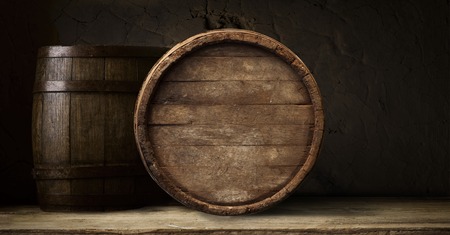 background of barrel and worn old table of woodの写真素材