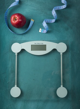 One red apple and tape measure placed on the old wooden.の写真素材