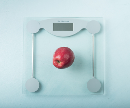 One red apple and tape measure placed on the old wooden.の写真素材