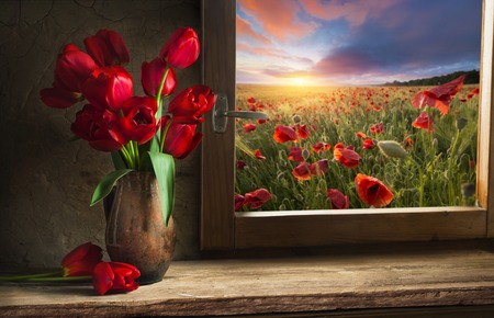 Bouquet of tulip flowers in vintage vase on the shelf over rough wooden background, rustic interior decorの写真素材
