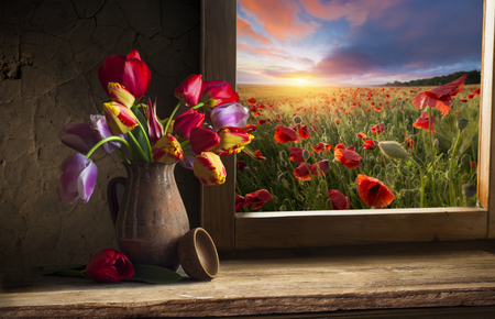 Bouquet of tulip flowers in vintage vase on the shelf over rough wooden background, rustic interior decorの写真素材