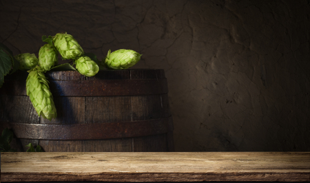 background of barrel and worn old table of wood.の写真素材