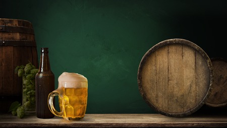 background of barrel and worn old table of woodの写真素材